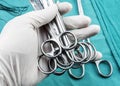 Surgeon working in operating room, hands with gloves holding scissors sutures, conceptual image