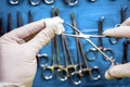 Surgeon working in operating room, hands with gloves holding scissors with torunda, conceptual image Royalty Free Stock Photo