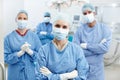 Surgeons with a commitment to excellent care. Portrait of a group of surgeons wearing hospital scrubs, face masks and Royalty Free Stock Photo