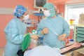 Surgeons discussing patient records in operation room at hospital