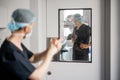 Surgeons entering door to an operation room