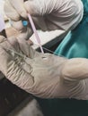 Surgeons hand holding a test tube with blood sample in a hospital. Royalty Free Stock Photo