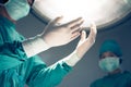 Surgeons hands and surgical lights in the operating room