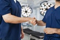 Surgeons Handshake in Operating Room Royalty Free Stock Photo