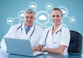 Surgeons with laptop against digitally generated background Royalty Free Stock Photo