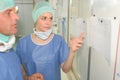 Surgeons team man and woman wearing protective uniforms