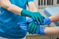 Surgeons joining hands together after work for rescue patient in operation room at hospital, emergency case, surgery Royalty Free Stock Photo