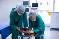 Surgeons using digital tablet in operation theater Royalty Free Stock Photo