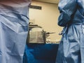 Surgeons using surgical instruments for keyhole surgery, watching the monitor which displays images from inside the patient`s abdo