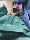 Surgeons using surgical instruments for keyhole surgery, watching the monitor which displays images from inside the patient`s abdo