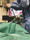 Surgeons using surgical instruments for keyhole surgery, watching the monitor which displays images from inside the patient`s abdo