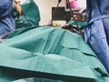 Surgeons using surgical instruments for keyhole surgery, watching the monitor which displays images from inside the patient`s abdo