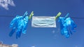 Surgery gloves and a mask hanging from a clothespin on the clothesline Royalty Free Stock Photo