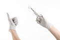 Surgery and medicine theme: doctor's hand in a white glove holding a surgical clamp with swab isolated on white background