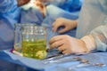 Surgery. The operating room nurse's hand rests on the instrument table