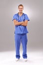 Surgery was a success. Full length portrait of a handsome male doctor standing with his arms folded. Royalty Free Stock Photo