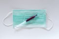 Surgical ear-loop mask and injection syringe Royalty Free Stock Photo