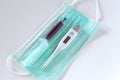 Surgical ear-loop mask, injection syringe and thermometer Royalty Free Stock Photo