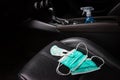 Surgical face mask for adult and small face mask for baby and ethyl Alcohol hand gel and placed on the car seat in car, Royalty Free Stock Photo