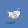 Surgical face mask on color background