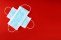 Surgical face mask for covid 19 coronavirus protection on red background Royalty Free Stock Photo