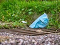 A surgical face mask used for COVID-19 PPE protection, discarded as litter Royalty Free Stock Photo