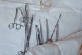 Surgical instruments made of steel including scalpels, forceps and tweezers, located on a white table. Medical equipment. Close-up Royalty Free Stock Photo