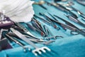 Surgical instruments in the operating room, laid out on a sterile table on a special blue tissue. The concept of