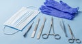 Surgical Instruments and Protective Gear on Blue Background Royalty Free Stock Photo