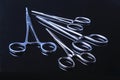Surgical instruments and tools including scalpels, forceps and tweezers on black mirror background. Royalty Free Stock Photo