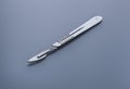 Surgical knife on a blue gray background Royalty Free Stock Photo