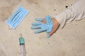 Surgical mask syringe and hand with torn gloves