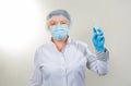 Surgical Nurse in cap and mask in medical clinic. A syringe with medicine is in the hands of a nurse. Close-up portrait. Health Royalty Free Stock Photo