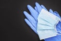 surgical protective tools face mask and latex gloves over black background with copy space. top view