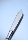 Surgical scalpel on a metal background