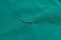 A surgical suture on the green table Royalty Free Stock Photo