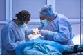 Surgical team performing surgery in modern operation theater,Team of doctors concentrating on a patient during a surgery