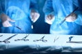 Surgical tools lying on the table while group of surgeons at background operating patient. Steel medical instruments Royalty Free Stock Photo