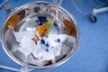 Surgical trash bin in the operating room with used bandage and syringe. Royalty Free Stock Photo