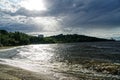 Surging wave on the Kyiv sea reservoir, water reflection, foam and sun beam