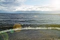 Surging wave on the Kyiv sea reservoir, water reflection, foam and sun beam