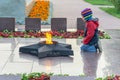 SURGUT, RUSSIA - SEPTEMBER 2, 2018: Boy at the eternal flame of the soviet soldier