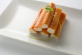 Surimi or crab sticks in a white rectangular plate. . White back Royalty Free Stock Photo