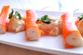 Surimi sticks with sauce on a white plate front view