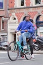 Surinam guy on a rusty blue bicycle, Amsterdam, Netherlands