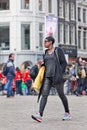 Suriname girl walks at Dam Square, Amsterdam, Netherlands