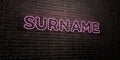 SURNAME -Realistic Neon Sign on Brick Wall background - 3D rendered royalty free stock image