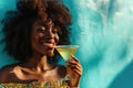 Surprise African Yearold Woman Sipping A Martini On Turquoise Background Royalty Free Stock Photo