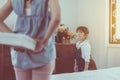 Surprise Asian little daughter with mother hiding gift box behind her back Royalty Free Stock Photo