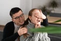 Surprise Beautiful romantic couple in cafe. Man is covering his girlfriend`s eyes while she waiting for a surprise Royalty Free Stock Photo